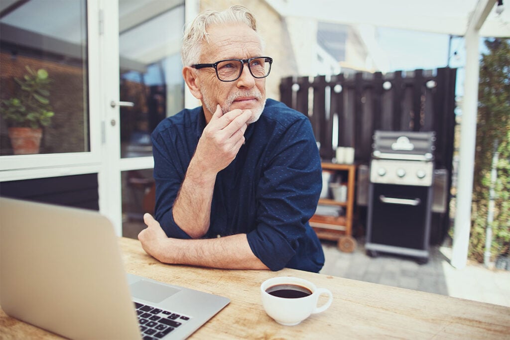 A grey haired man thinks about translation certifications_scaled